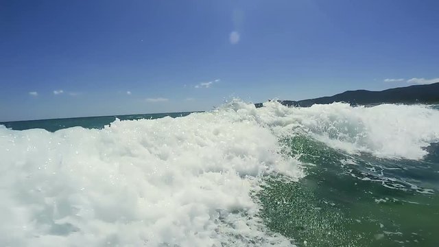 Man Swimming on Surfing Board in Ocean