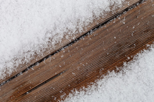 Snow on boards of a wooden bench. New year and christmas theme