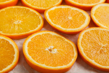Abstract background with citrus orange slices on parchment paper. Close up. Top view. Studio photography.