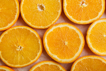 Abstract background with citrus orange slices on parchment paper. Close up. Top view. Studio photography.