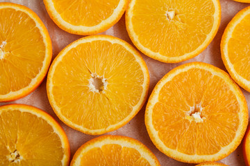 Abstract background with citrus orange slices on parchment paper. Close up. Top view. Studio photography.