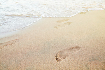 Foot prints on the beach of a seashore near the sea