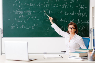 Female math teacher in front of the chalkboard 