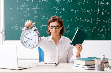 Female math teacher in front of the chalkboard 