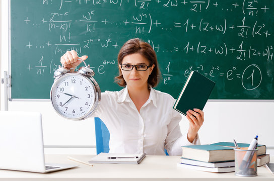 Female math teacher in front of the chalkboard - Powered by Adobe