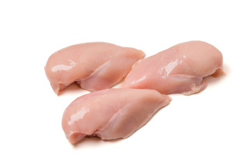 Raw chicken fillets close up on white