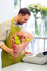 small business, sale and floristry concept - happy smiling florist with bunch at flower shop