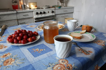 tea with honey and plum covered table