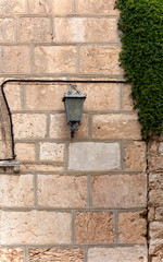 lantern on the stone wall of the building