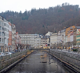 people are walking by riverside in Karlovy Vary