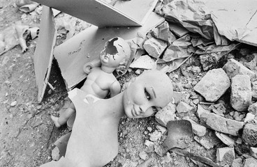 1980 Vintage analog photography of old discarded and destroyed woman and child mannequins in midst...