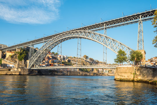 Fototapeta The Dom Luis I Bridge is a famous double-decker metal arch bridge that spans the Douro River between the cities of Porto and Vila Nova de Gaia in Portugal. 