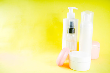 Personal care concept, cosmetics bottles, jars. Skin care products. Relax and spa. On a bright yellow background.