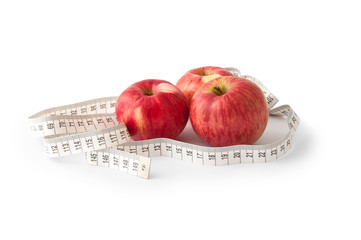 Three red apples with measuring tape. Slimming concept