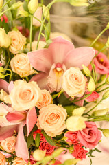 Bouquet with orchids and roses on a beautiful background