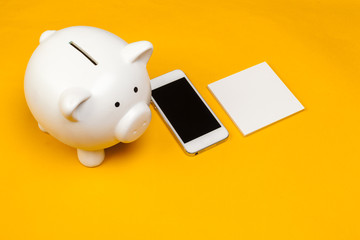 Piggy bank with mobile phone.