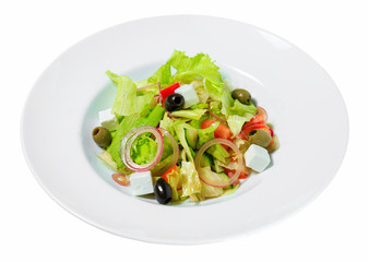 Salad Greek with olives, onion, feta cheese, romaine lettuce and tomatoes on a plate.