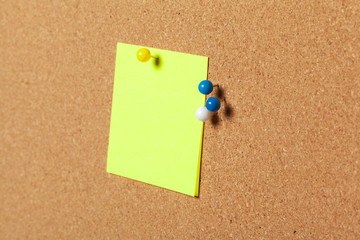 colorful sticky notes with pushpins and blank space,  on cork background
