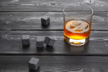 Whiskey and whiskey stones on a wooden table