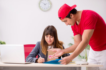 Courier delivering parcel to the office