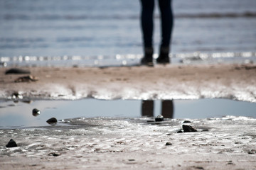 Abstract background with feet on the sandy beach