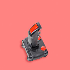 Retro computer gaming controller isolated on pink background.