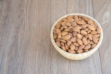 Almond nut on wood background.