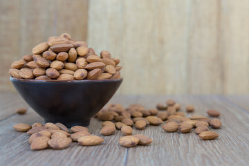 Almond nut on wood background.