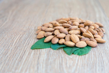 Almond nut on wood background.
