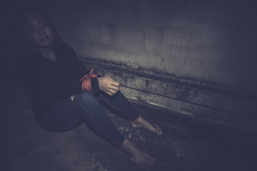 Asian hostage woman Bound with rope at night scene,The thieves kidnapped for ransom,thailand people