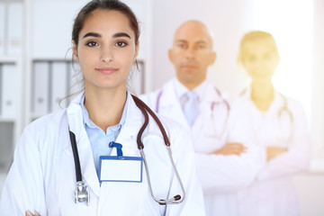 Fototapeta premium Happy doctor woman with medical staff at the hospital