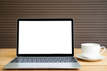 Fototapeta premium Coffee cup with laptop mockup on wood
