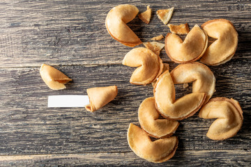 Cracked fortune cookies with blank paper