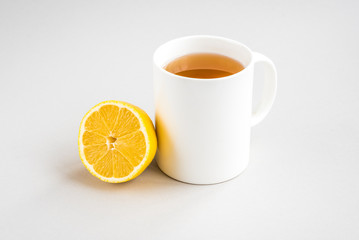 Mug of hot tea with lemon on gray background. Catarrhal disease. Flu season.