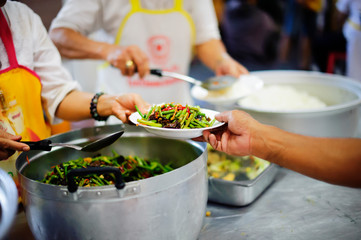 Feeding Food To Poor, Using leftovers to feed the hungry : concept serving free food to the poor