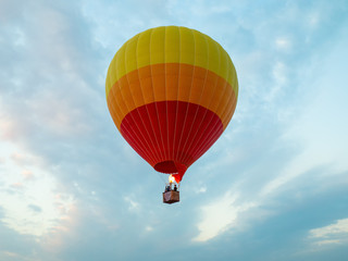 hot air balloon over the green paddy field. Composition of nature and blue sky background.
