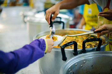 Feeding Food To Poor, Using leftovers to feed the hungry : concept serving free food to the poor