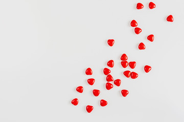 Valentines day background with red candy hearts, top view