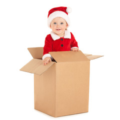 Cute baby-santa with beautiful blue eyes inside the box isolated on white. Christmas, xmas, winter concept. Happy childhood. Santa baby looking at camera from paper box.