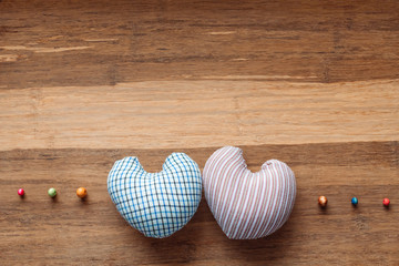 Two textile hearts on a wooden background. Rural Valentine's Day Concept