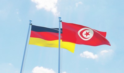 Tunisia and Germany, two flags waving against blue sky. 3d image