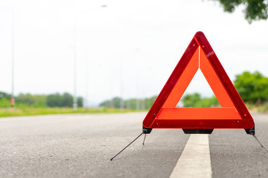 breakdown triangle stands alongside the road..Car broke down sign on road concept.