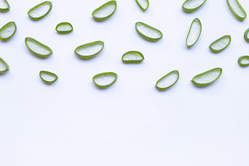 Aloe vera slices on white background.