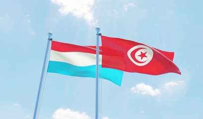 Tunisia and Luxembourg, two flags waving against blue sky. 3d image