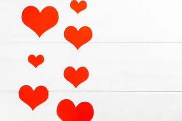 red hearts on a white wooden background frame