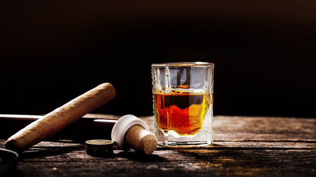 Whisky and cigar on the timber table