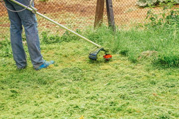 man mows the grass close up