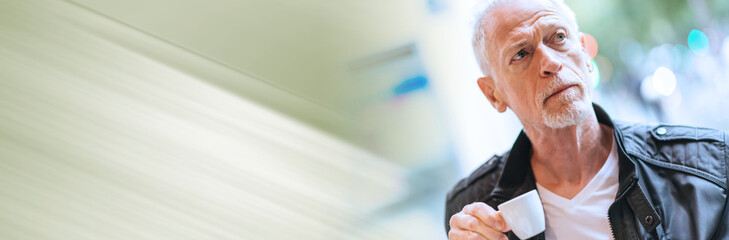 Portrait of mature man drinking coffee. panoramic banner