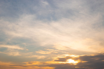 Clouds and sky scene with bright light at sunset