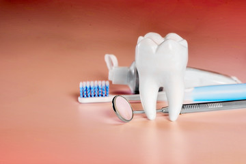 White big healthy tooth and different tools for dental care, on living coral gradient dental background.
